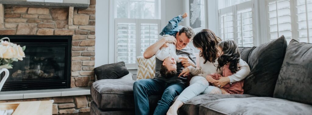 Family in their home playing with children